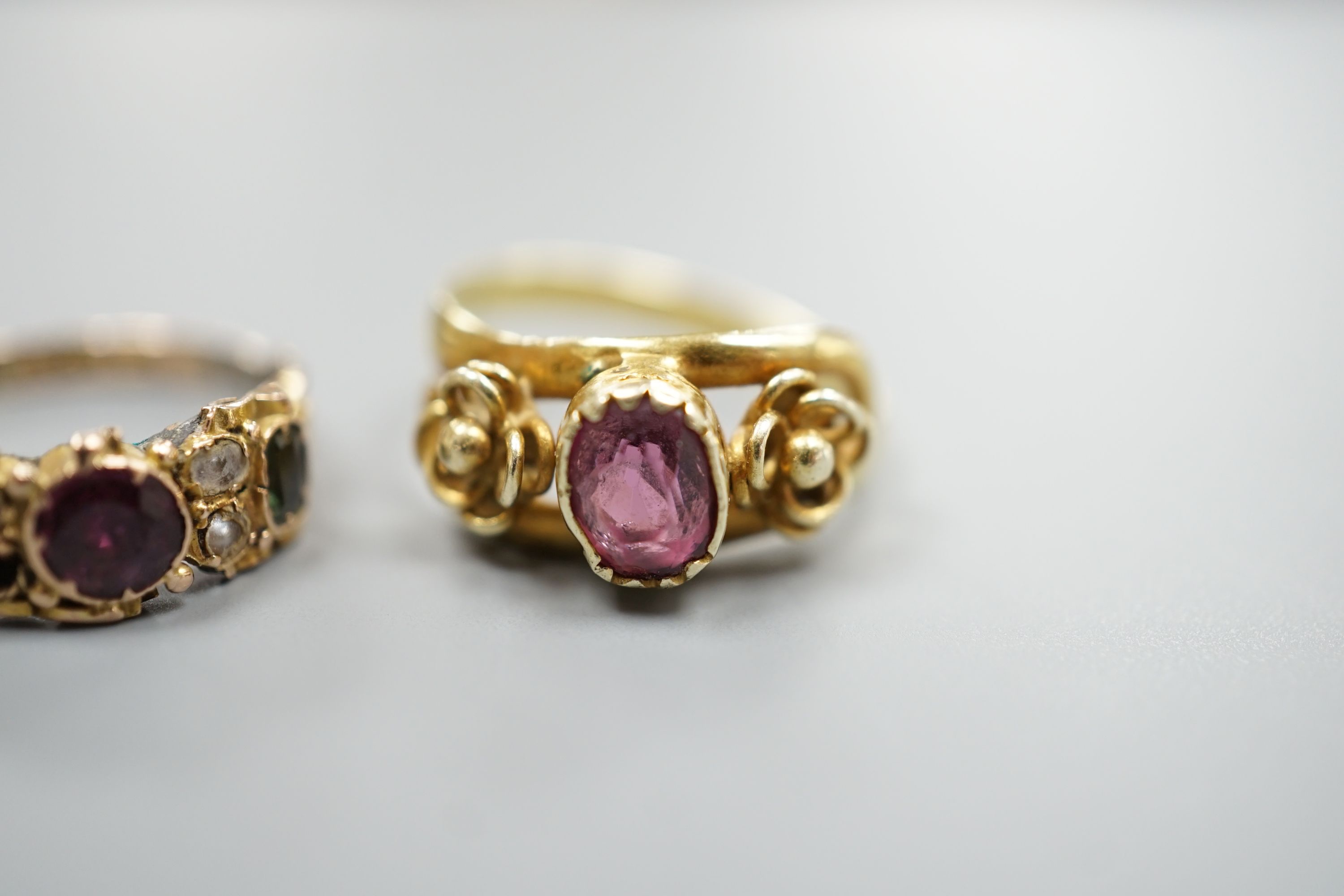 A Victorian gold, garnet and seed pearl set dress ring, size N/O and a yellow metal and garnet set ring, gross 5 grams.